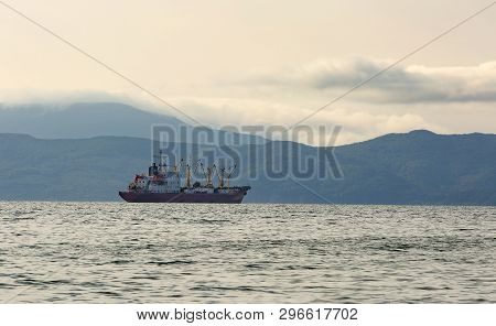 The Fishing Boat In Gray Morning On Pacific Ocean Off The Coast Of The Kamchatka Peninsula