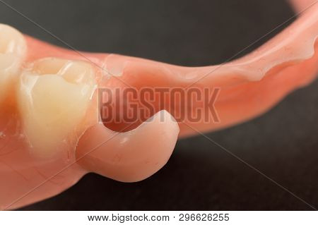 Large Image Of A Modern Nylon Denture On A Black Background