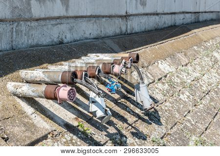 Old Damaged Electric Plug Power Line Installations On The River Shore Or Ocean Marine For Yachts Boa