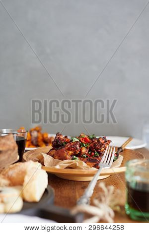 Low Angle View Of Table Served With Traditional British Sunday Roast Dinner, Featuring Roasted Chick