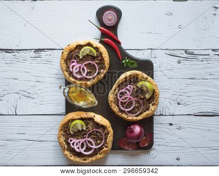 Arabian Opened Meat Pies Sfiha On Wooden Cutting Board. Top View.