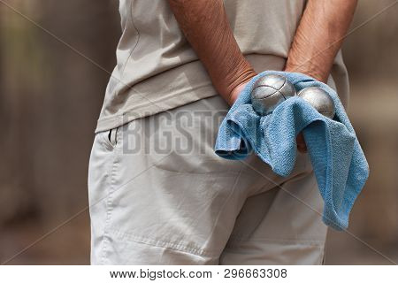 Hand Of Holding Petanque Ball,close Up Of People At Sport,seniors Playing The French Game Petanque