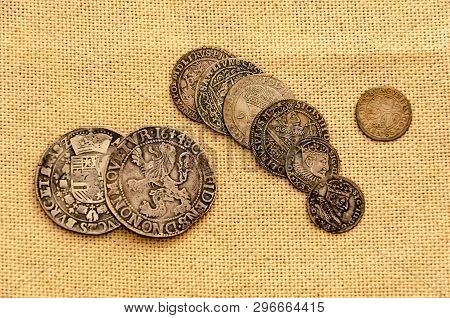 Pail Of Thalers. Old Silver Coins On Linen Background