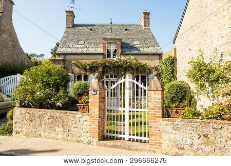 Barfleur, France - August 29, 2018: Traditional Granite House And Beautiful Courtyard In Barfleur. N