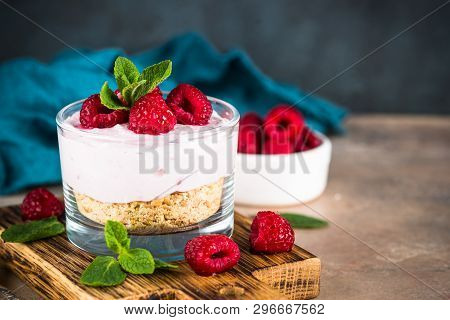 No Baked Cheesecake With Raspberry In Glass Jar. Healthy Dessert.