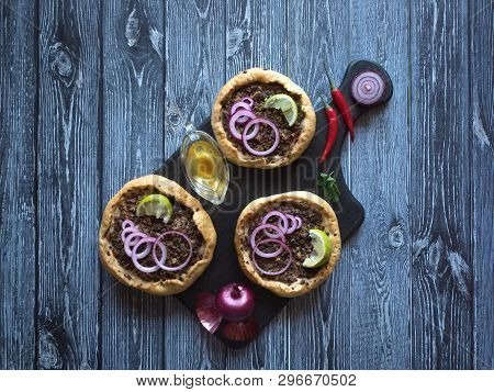 Arabian Opened Meat Pies Sfiha On Wooden Cutting Board. Top View.