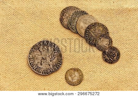 Pail Of Thalers. Old Silver Coins On Linen Background