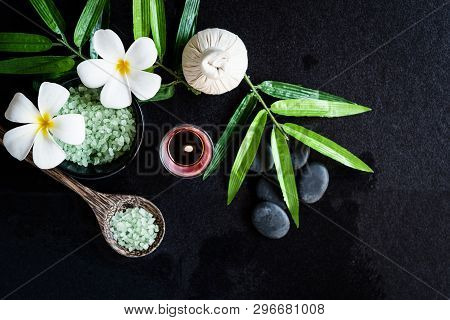 Thai Spa.  Top View Of White Plumeria Flower Setting For Massage Treatment And Relax On Black Blackb