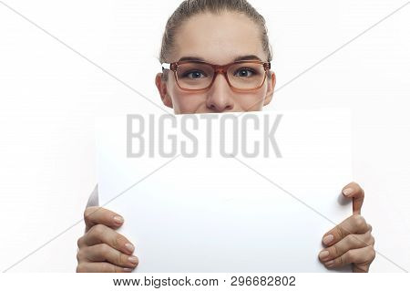 Young Woman In Pink Blouse Long Hair In Tail In Eyeglasses Smiling Holding A Blank White Banner On W