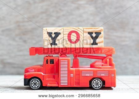 Red Fire Truck Hold Letter Block In Word Yoy (abbreviation Of Year Over Year) On Wood Background