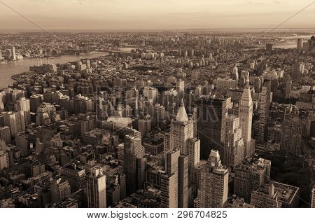 New York City rooftop view with downtown Manhattan skyscrapers and urban cityscape.