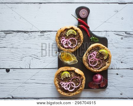 Arabian Opened Meat Pies Sfiha On Wooden Cutting Board. Top View.