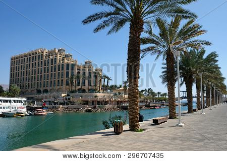 Eilat, Israel - March 04, 2019: View Of The Palm Tree Lane Along The Lagoon And The Queen Of Sheba H