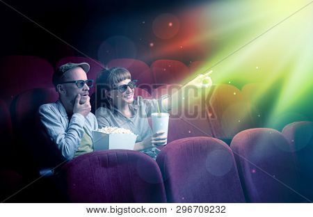 Teenager couple cuddling and watching the climax part of the movie