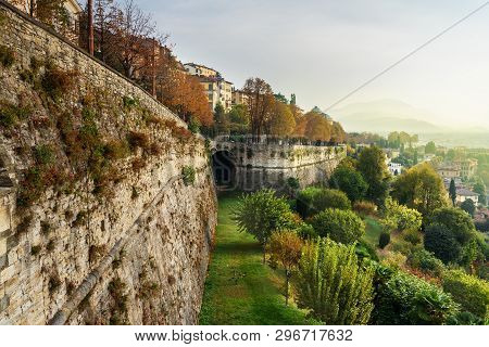 View Of Bergamo City With Sant Andrea Platform Of Venetian Walls At Morning. Italy