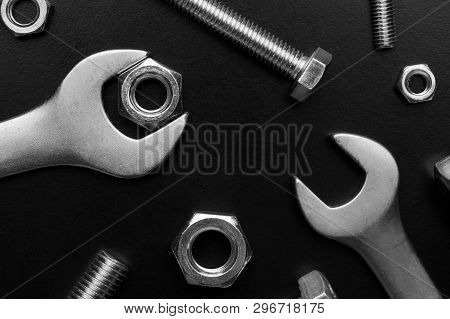 Wrenches And Bolts With Nuts On A Black Background.bolts And Nuts Close Up. Tools For Work. Bolts An