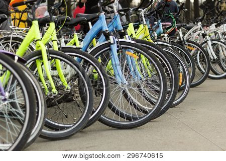 Group Of Bicycles For Rent Parked In Tight To Each Other