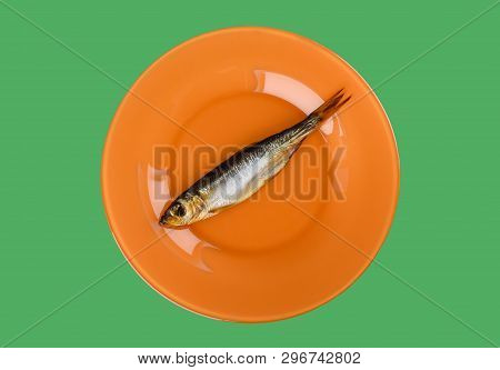 Cold Smoked Baltic Herring On An Orange Plate Isolated On Green Background. Smoked Baltic Herring Sm