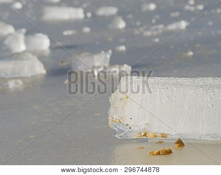 Thin Icy Board Against Strong Sun Light. In Ice Floe Are Visible Deep Cracks. Melting Of Arctic Ice