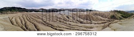 Panoramic View Of An Arid Landscape Created By The Mud Volcanoes In Berca, Romania. A Mud Volcano Or