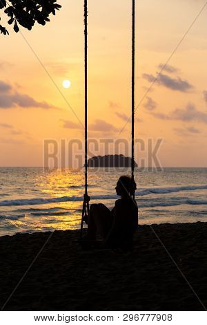 Travel Blog Photo: Silhouette Of A Woman In A Dress During Sunset With A View Over Sea With A Small 