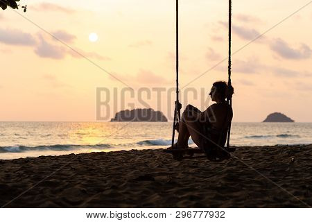 Travel Blog Photo: Silhouette Of A Woman In A Dress During Sunset With A View Over Sea With A Small 