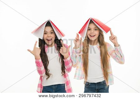 Knowledge Is Power. Adorable Little School Girls Holding Books Over Heads Full Of Knowledge. Septemb