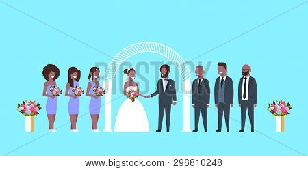 Just Married Bride And Groom With African American Bridesmaids Groomsmen Standing Together Near Arch