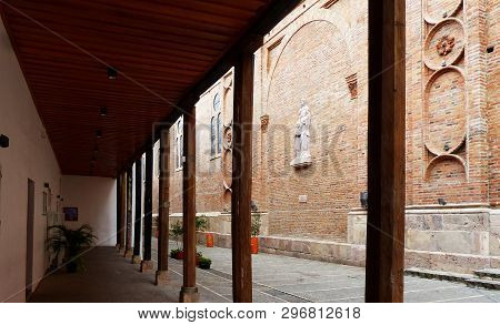 Cuenca, Ecuador - March 8, 2019: Narrow Street Santa Ana And Relief Sculpture Of Saint Anna And Sain