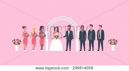 Just Married Bride And Groom With Bridesmaids Groomsmen Standing Together Near Arch Wedding Ceremony