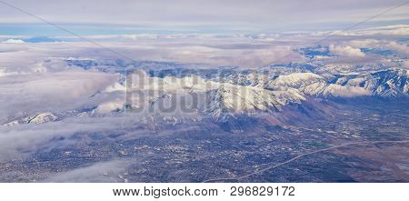 Aerial View From Airplane Of The Wasatch Front Rocky Mountain Range With Snow Capped Peaks In Winter