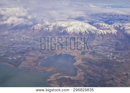 Aerial View From Airplane Of The Wasatch Front Rocky Mountain Range With Snow Capped Peaks In Winter