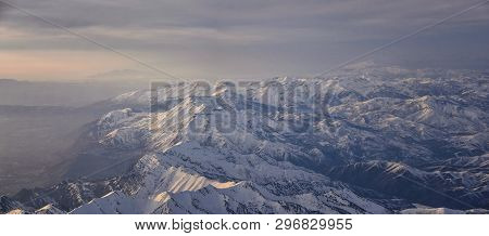 Aerial View From Airplane Of The Wasatch Front Rocky Mountain Range With Snow Capped Peaks In Winter