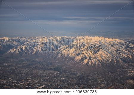 Aerial View From Airplane Of The Wasatch Front Rocky Mountain Range With Snow Capped Peaks In Winter