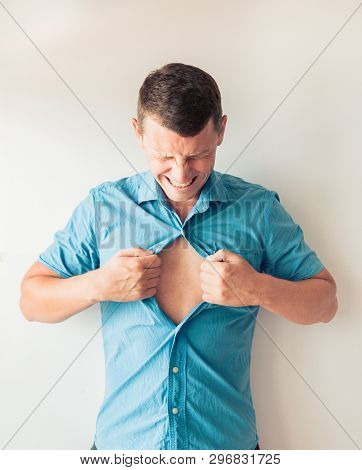 Businessman Tearing Off His Shirt And Showing Mucular Body Concept On Background