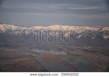 Aerial View From Airplane Of The Wasatch Front Rocky Mountain Range With Snow Capped Peaks In Winter