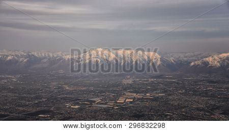 Aerial View From Airplane Of The Wasatch Front Rocky Mountain Range With Snow Capped Peaks In Winter