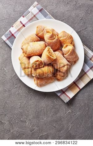 Mini Pie One Bite Crescents Shape, Kifli, Rohalik With Apple Filling Served On A White Plate,vertica