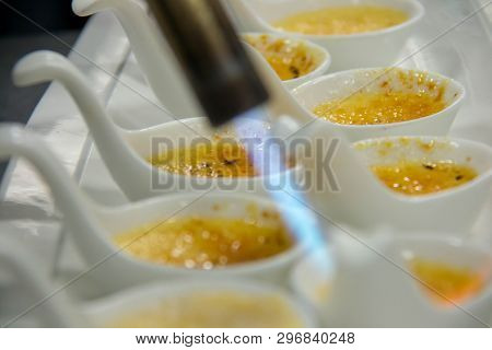 A Cream Brûlée In A White Spoon