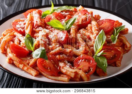 Freshly Cooked Casarecce Pasta With Tomato Sauce, Parmesan And Basil Closeup On A Plate. Horizontal