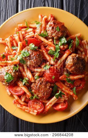 Tasty Pasta Casarecce With Meatballs In Tomato Sauce Close-up On A Plate. Vertical Top View