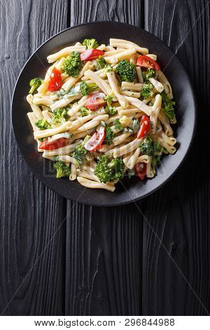 Pasta Casarecce Recipe With Vegetables, Herbs, Seasoned With Creamy Cheese Sauce Close-up On A Plate
