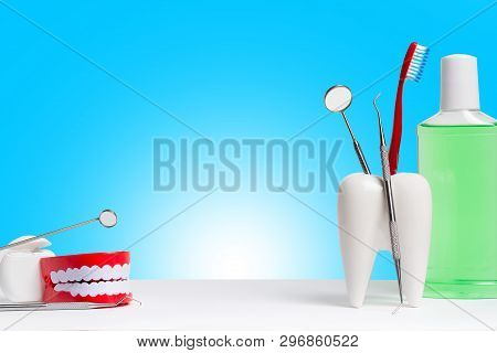 Dental Health And Teethcare Concept. Dental Mirror With Explorer Probe And Toothbrush In White Tooth