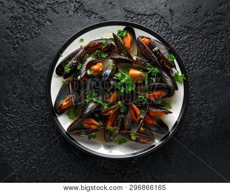 Mussels With White Wine, Garlic, Lemon And Herbs In A Plate, Rustick Background. Seafood.