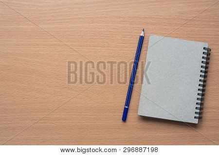 Notepad With Pencil On Wood Board Background.using Wallpaper For 
Education, Business Photo.take Not