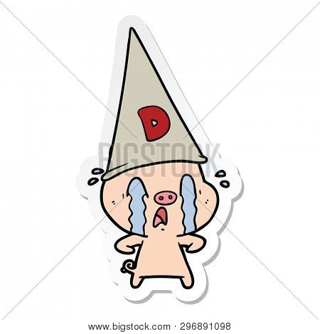 sticker of a crying pig wearing dunce hat