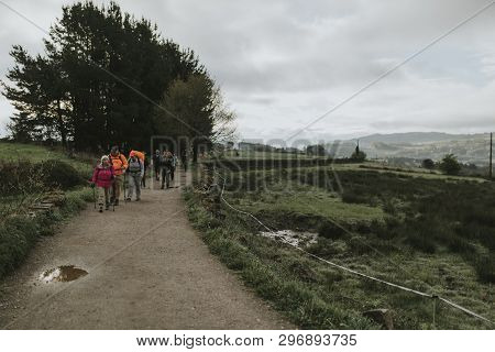 Sarria, Spain - April 6th, 2019: Group Of Pilgrims With Backpack Walking By Camino De Santiago Way I