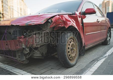 Red Car With Rumpled Bonnet And Bumper
Old Car With Rumpled Metal Bonnet Parked On Paved Parking Spo