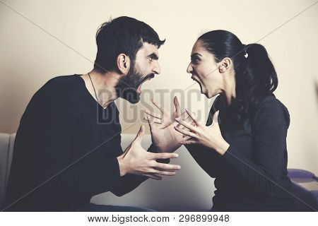 Couple Having Arguement  Sitting In The Sofa