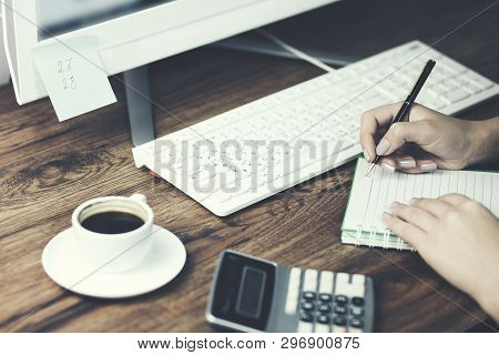 Businesswoman Hand Keyborad And Notepad On Office Table